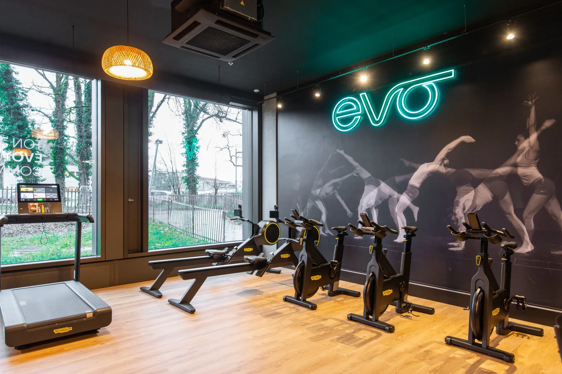 evo fitness geneva green village cardio area neon logo wall graphic